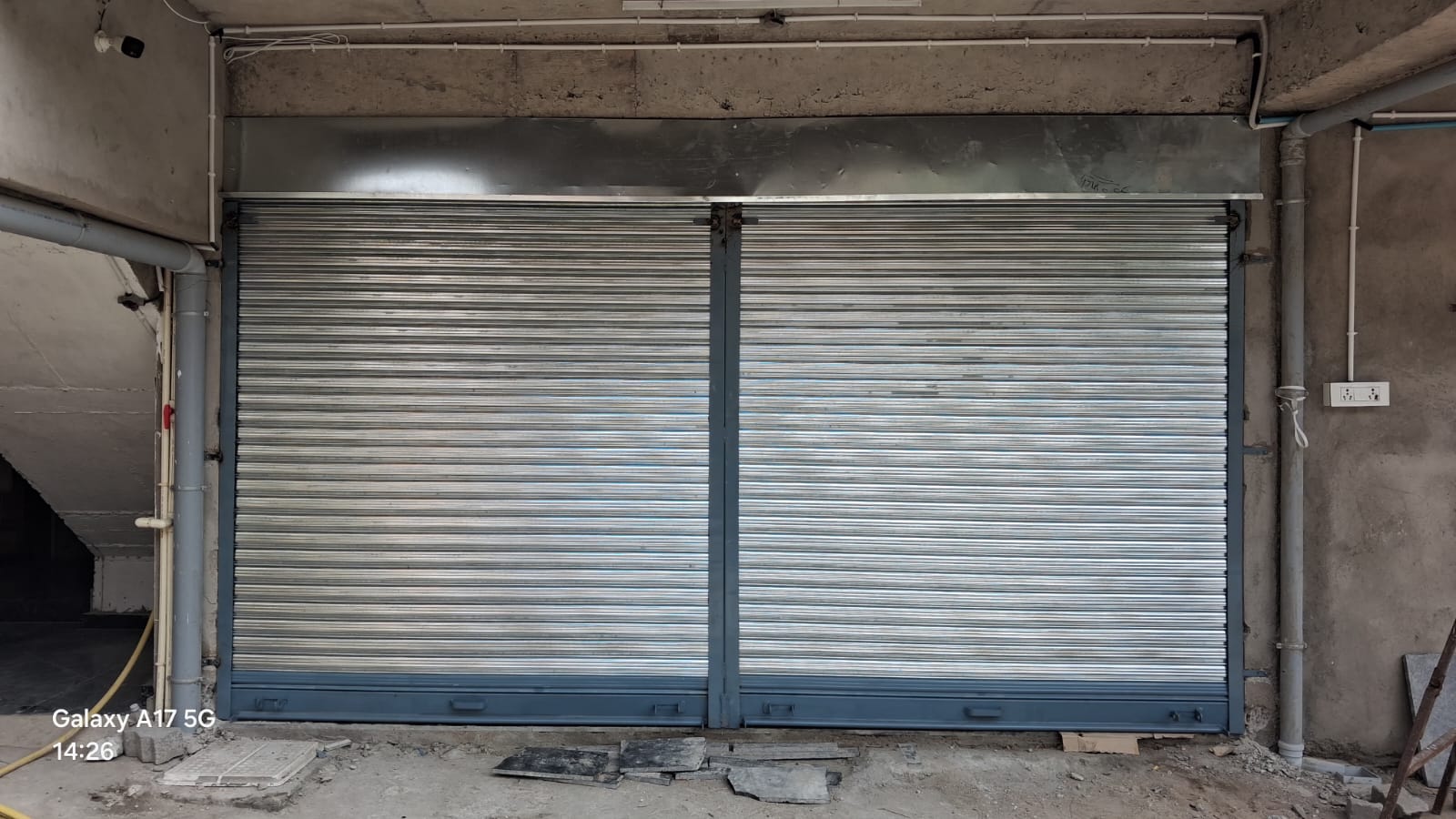 Twin GI rolling shutters corner installation, Nagpur